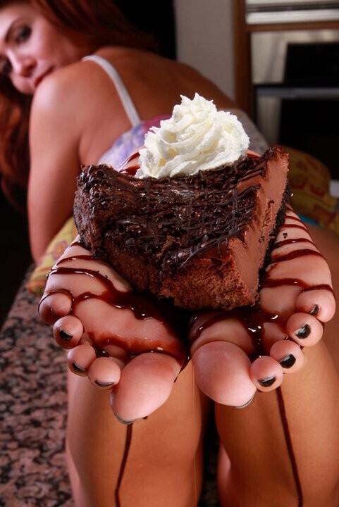 You balance a sweet treat on your lovely feet, enticing your opponent to taste them.